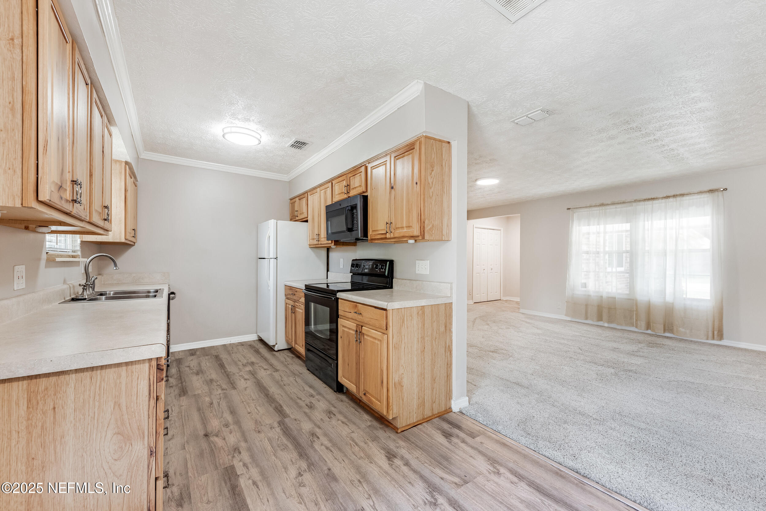 6149 Post Oak Road West Jacksonville, FL 32277 - Photo 10 of 25 a kitchen with granite countertop a stove top oven a sink dishwasher and a refrigerator with wooden floor
