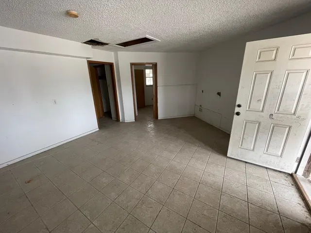 a bathroom with a granite countertop shower and a toilet
