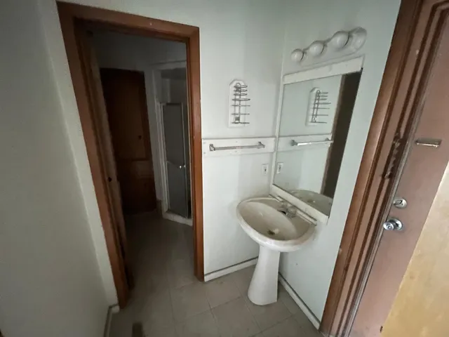 a bathroom with a granite countertop sink and toilet