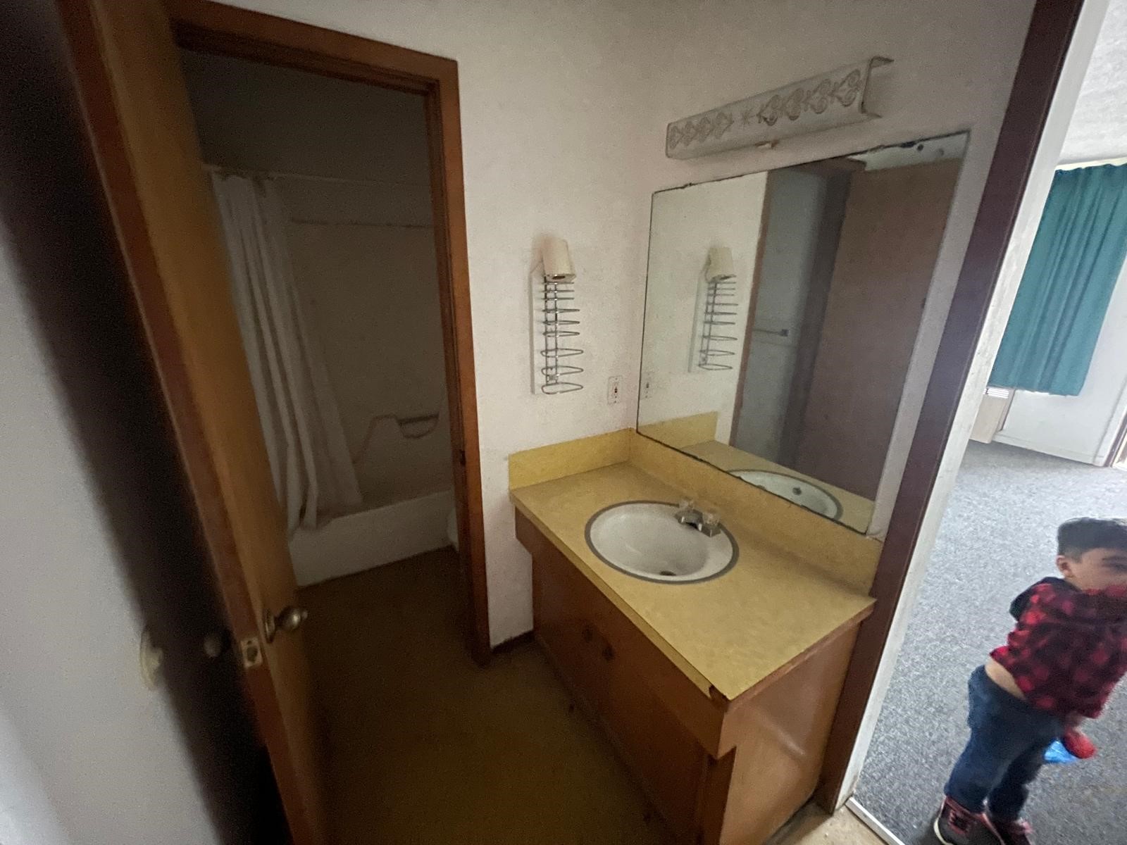 4602 Avenue H Rosenberg, TX 77471 - Photo 23 of 25 a bathroom with a sink a toilet and shower