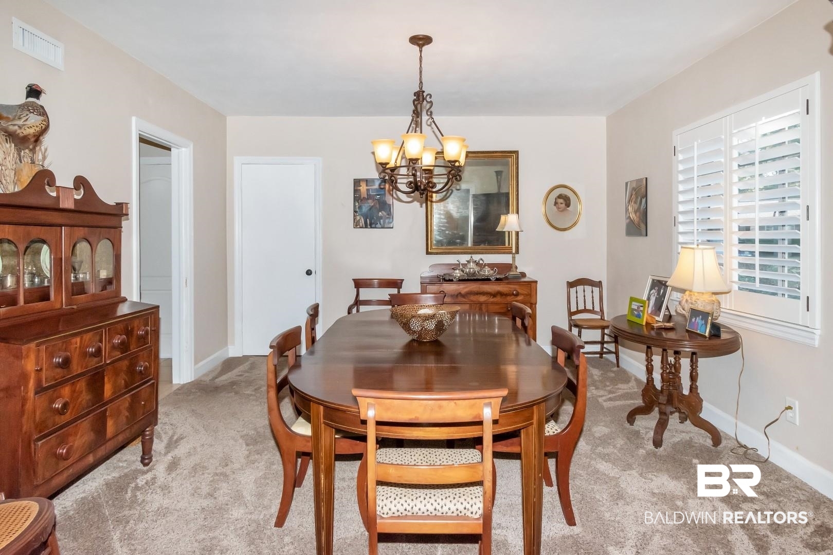 302 Springwood Drive East Mobile, AL 36608 - Photo 7 of 35 Carpeted dining room with a notable chandelier