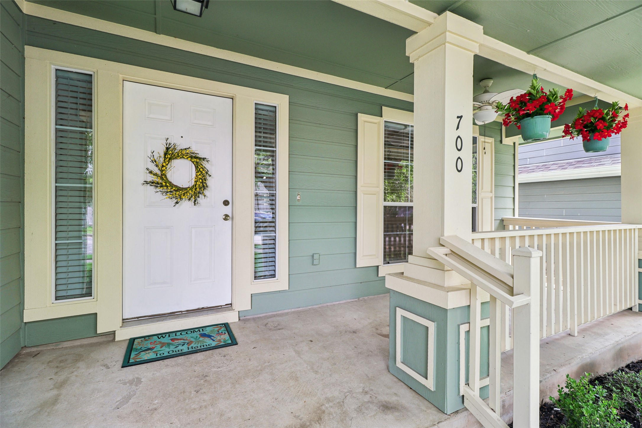 700 Scheel Road Kyle, TX 78640 - Photo 2 of 39 The property features a welcoming covered front porch with a white entry door, framed by sidelight windows