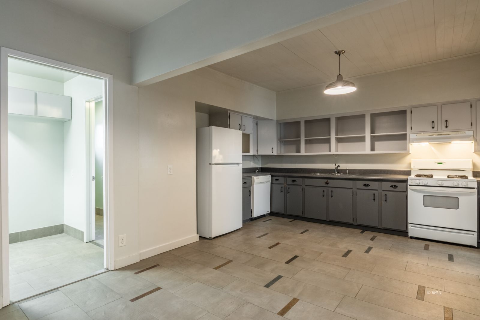 211 South Washington Street Lone Pine, CA 93545 - Photo 14 of 25 a kitchen with stainless steel appliances a stove sink and refrigerator