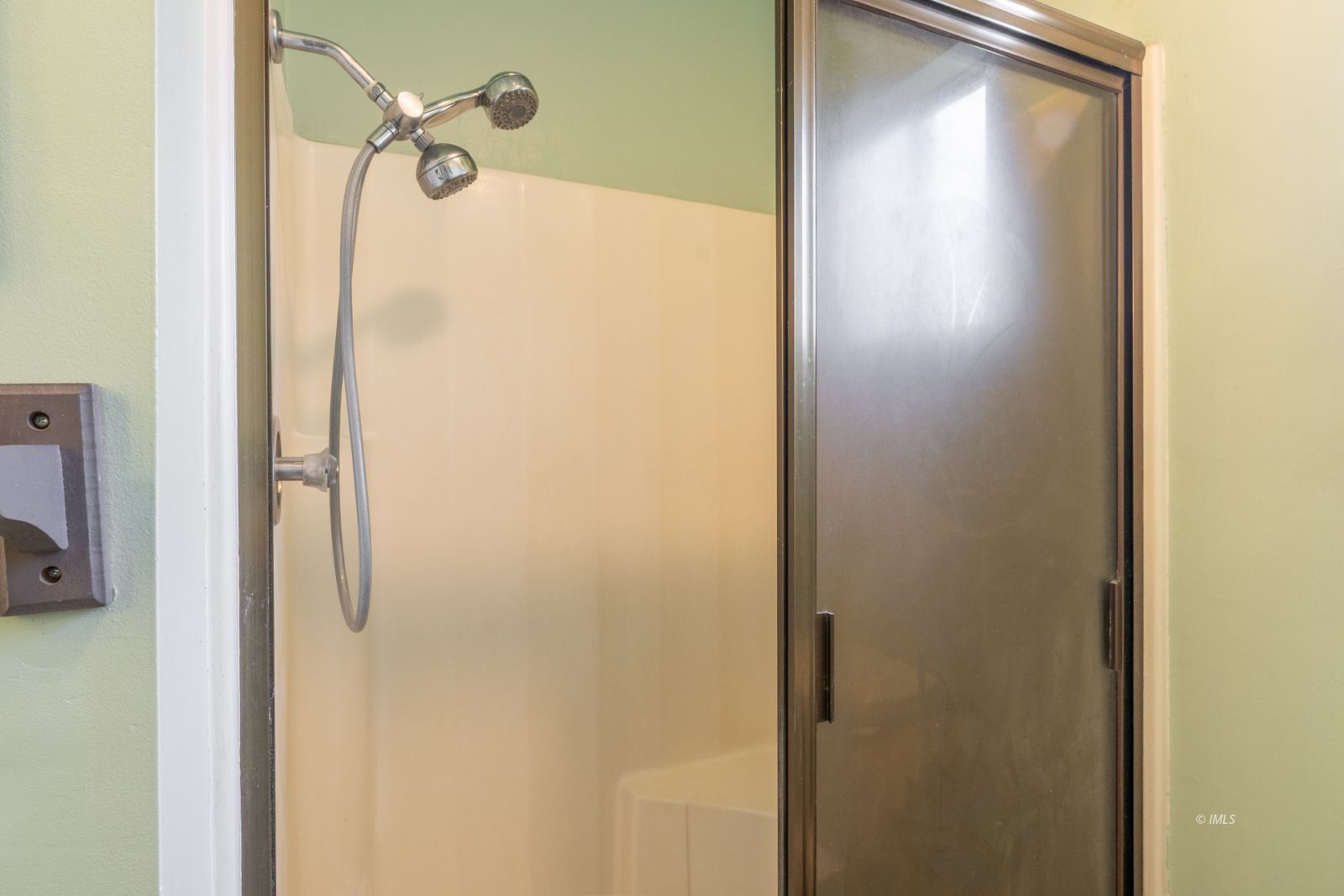 211 South Washington Street Lone Pine, CA 93545 - Photo 17 of 25 a bathroom with a glass shower door