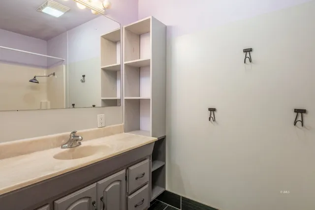 a bathroom with a sink and a mirror