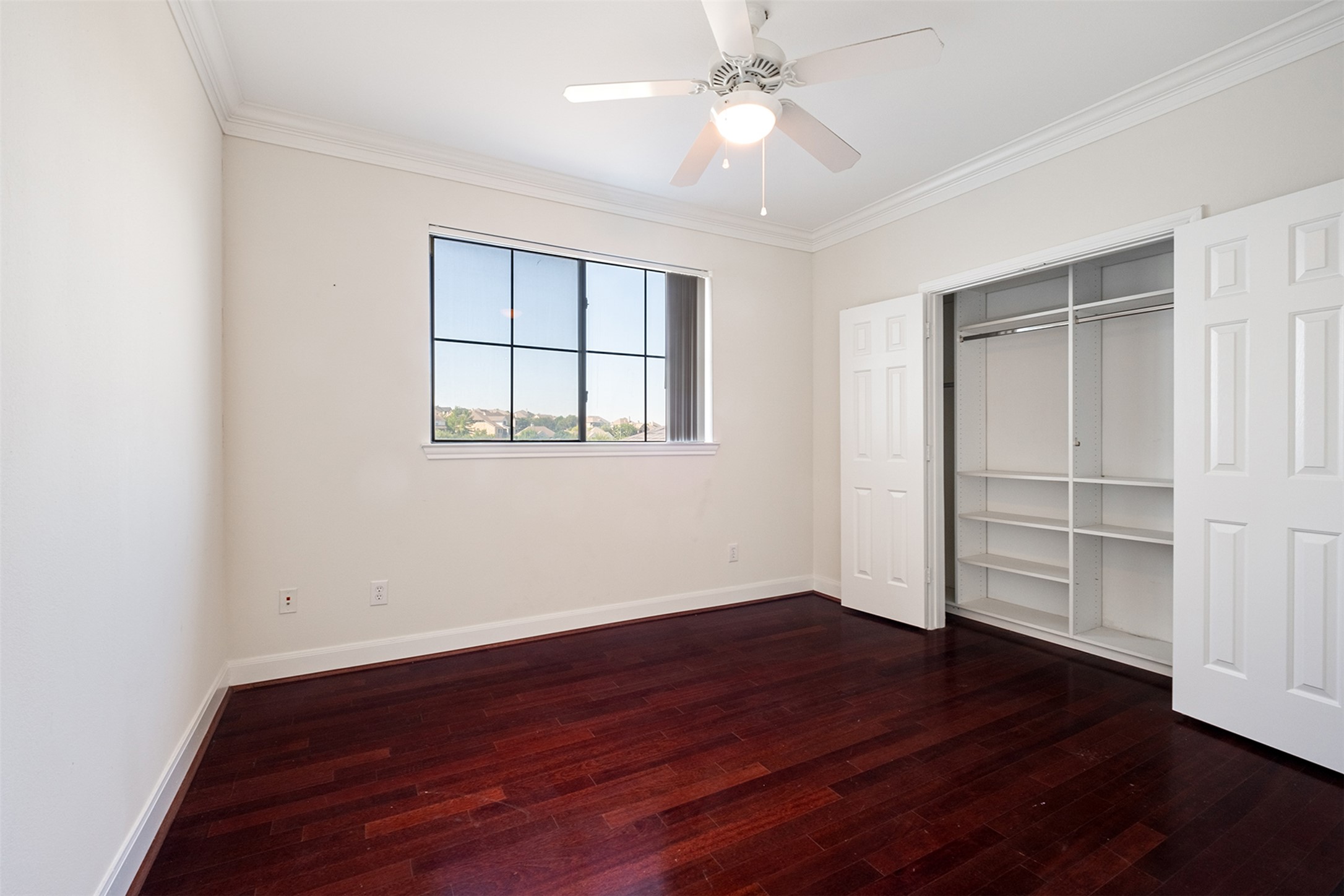 7701 Rialto Boulevard, Unit 637 Austin, TX 78735 - Photo 6 of 25 Rich hardwood floors complement this light-filled room featuring a large window and built-in closet.