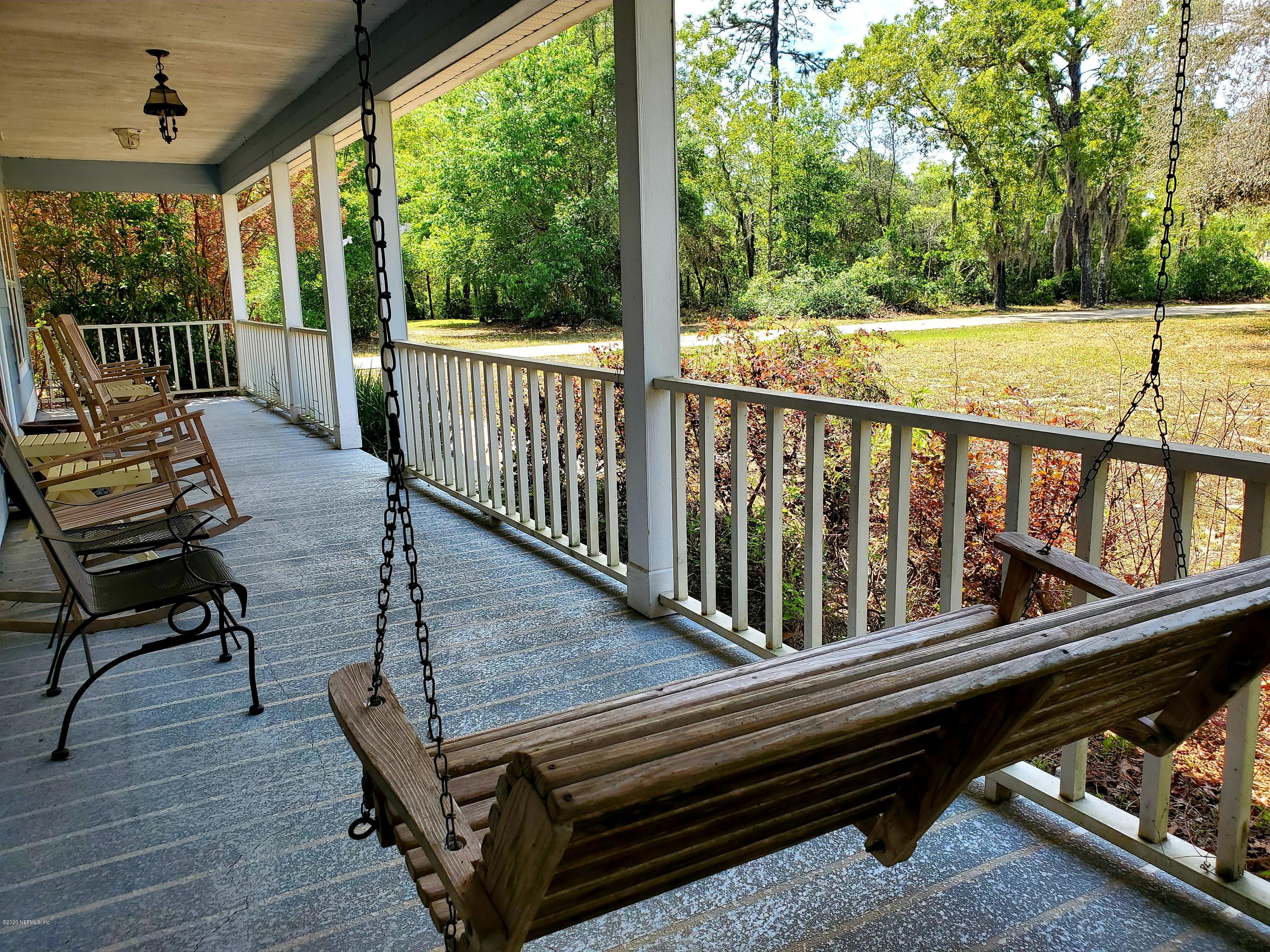7001 Elfo Road Keystone Heights, FL 32656 - Photo 2 of 6 a view of a balcony with wooden floor and outdoor seating