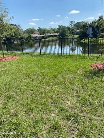 a view of a lake with a house in the background
