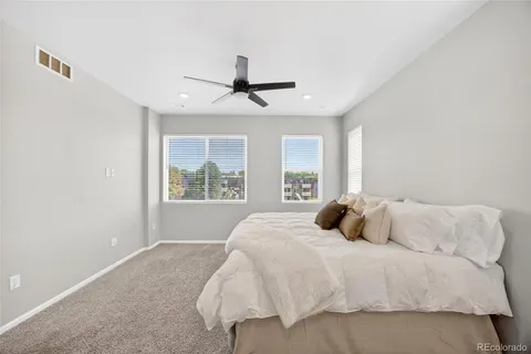 a bedroom with a large bed and a window