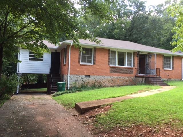 2803 Oakland Terrace Decatur, GA 30032 - Photo 1 of 1 a front view of a house with a yard and garage