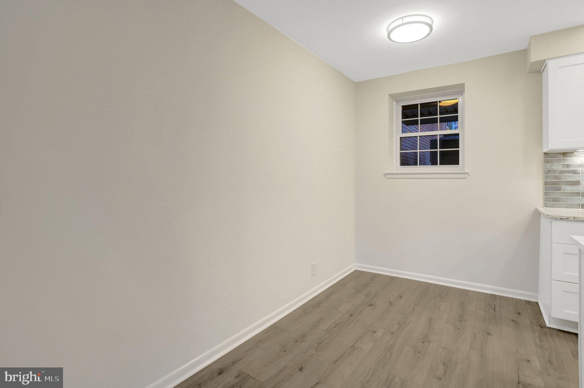 4619 28th Road South, Unit A Arlington, VA 22206 - Photo 11 of 30 an empty room with wooden floor and windows