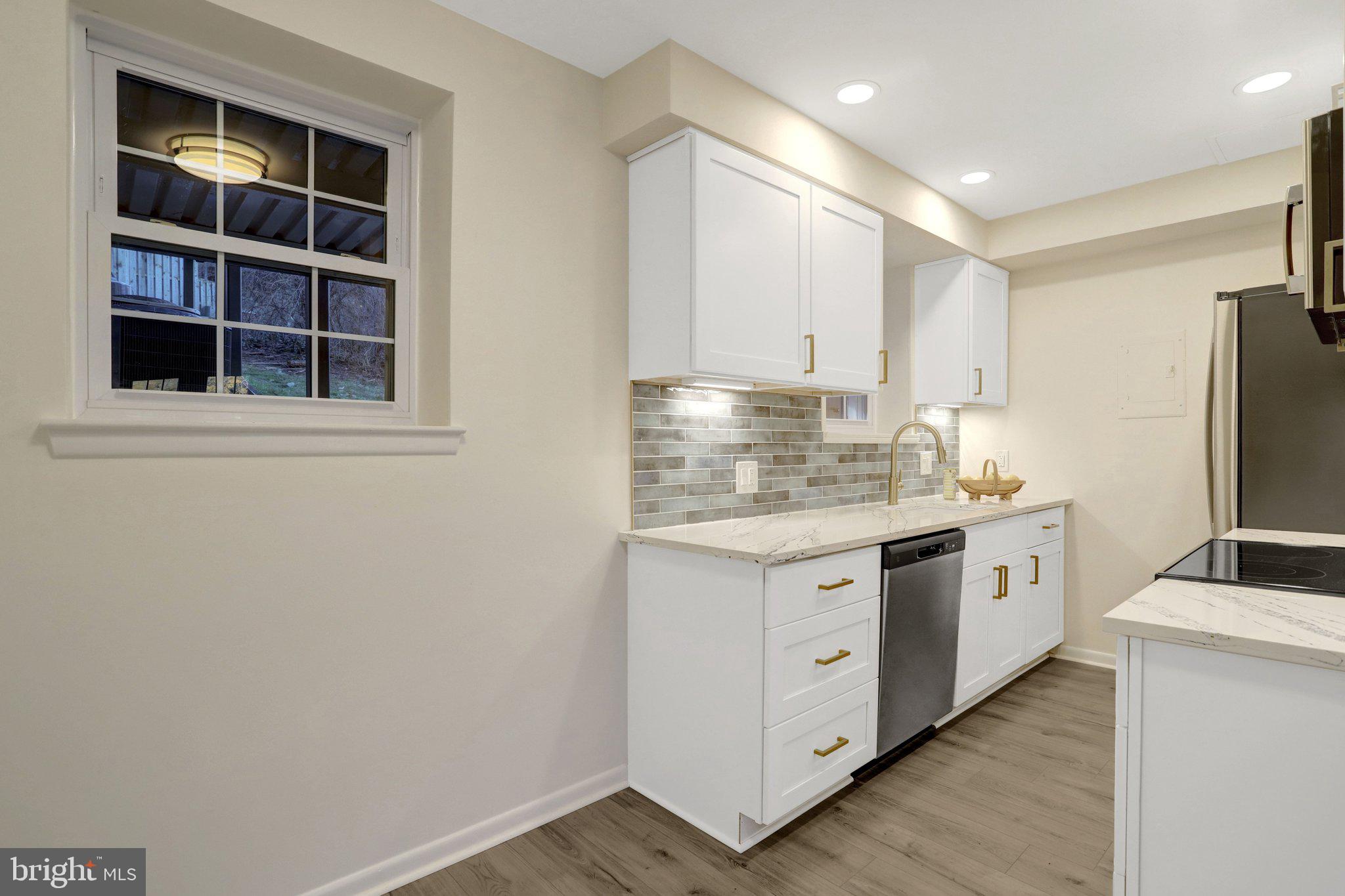 4619 28th Road South, Unit A Arlington, VA 22206 - Photo 13 of 30 a kitchen with stainless steel appliances granite countertop a stove and a refrigerator