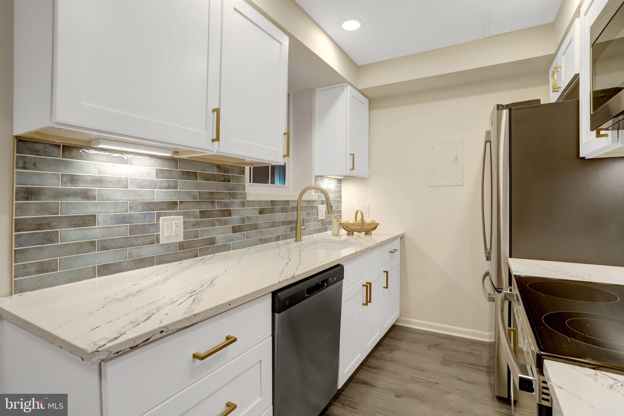 4619 28th Road South, Unit A Arlington, VA 22206 - Photo 14 of 30 a kitchen with granite countertop white cabinets and white appliances