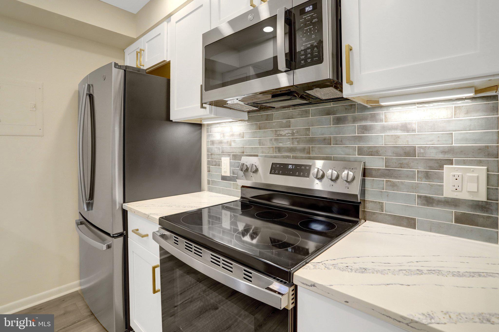 4619 28th Road South, Unit A Arlington, VA 22206 - Photo 15 of 30 a stove top oven sitting inside of a kitchen