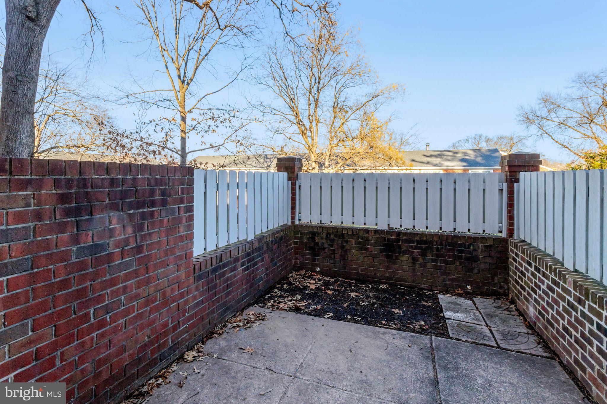 4619 28th Road South, Unit A Arlington, VA 22206 - Photo 28 of 30 a view of a yard with wooden bench and trees