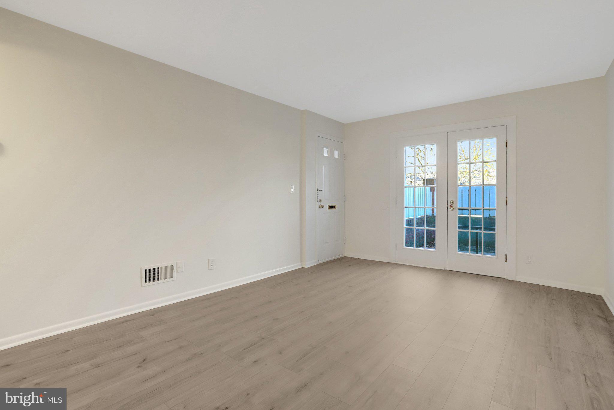 4619 28th Road South, Unit A Arlington, VA 22206 - Photo 5 of 30 a view of an empty room with wooden floor and a window