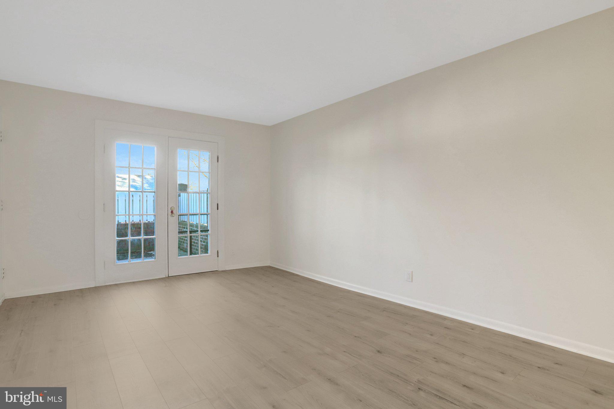 4619 28th Road South, Unit A Arlington, VA 22206 - Photo 7 of 30 a view of an empty room with wooden floor and a window