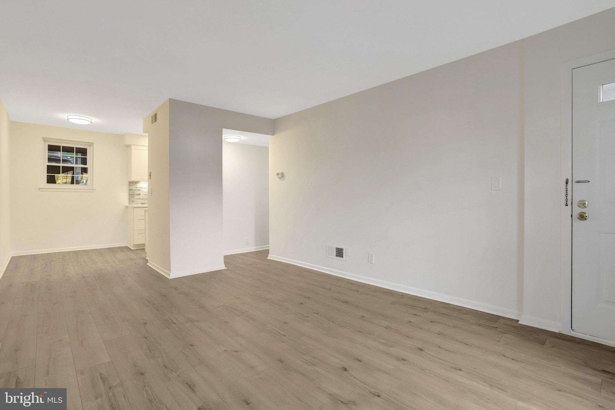 4619 28th Road South, Unit A Arlington, VA 22206 - Photo 9 of 30 a view of an empty room with wooden floor and a window