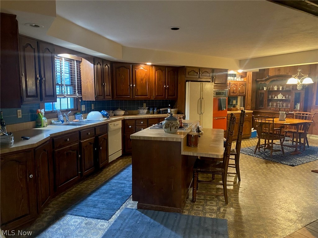 30300 Oakdale Road Willowick, OH 44095 - Photo 5 of 10 Kitchen featuring center eat in area island and stove. Plenty of room for a table and chair eating area too.
Kitchen with two eating areas. Plenty of room for a table and chairs plus a center island eat in area and stove.
Cabinets galore in this home. Recessed lighs too.