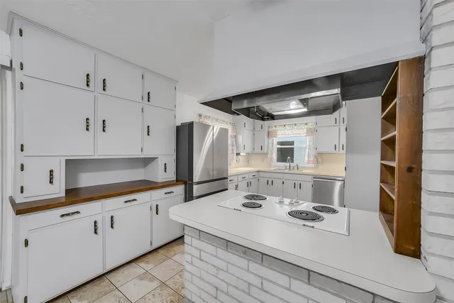 a kitchen with a sink cabinets and window