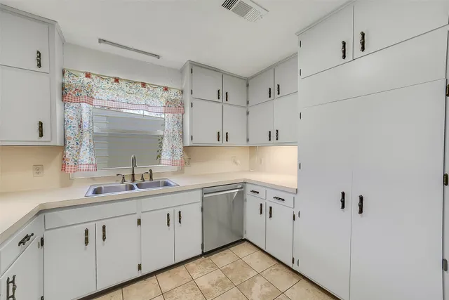 a kitchen with white cabinets sink and white appliances