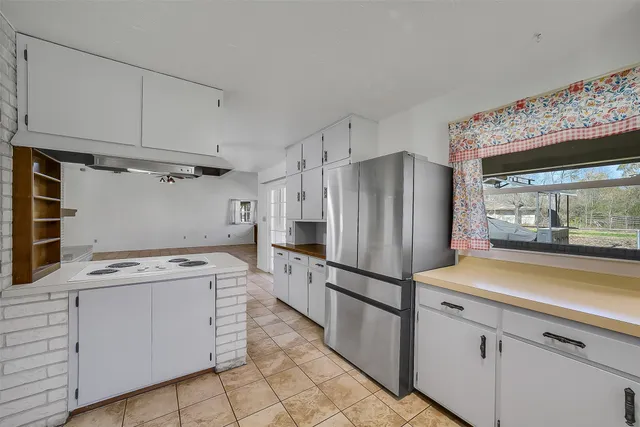 a kitchen with a stove cabinets and refrigerator