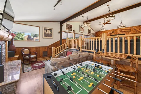 a living room with furniture a couch and chandelier
