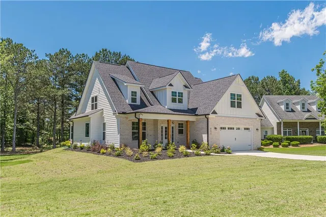 a front view of a house with swimming pool having outdoor seating