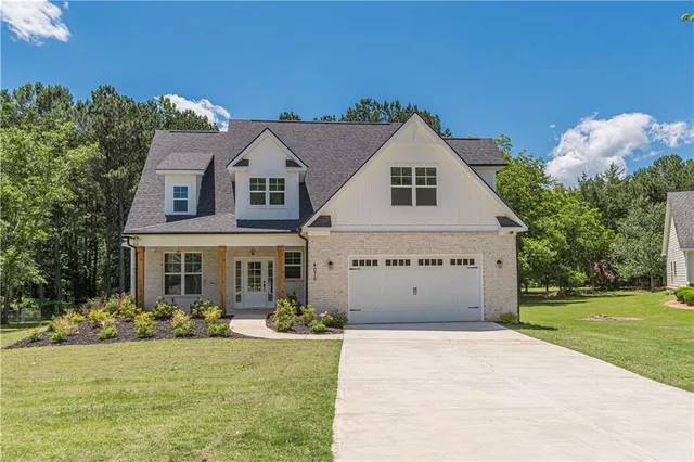 a pathway of a house with a yard