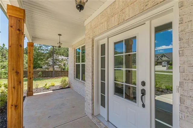 a view of a hallway with wooden floor and closet area