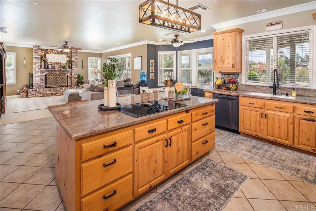 25057 Poderio Drive Ramona, CA 92065 - Photo 11 of 36 a large kitchen with kitchen island granite countertop a large window