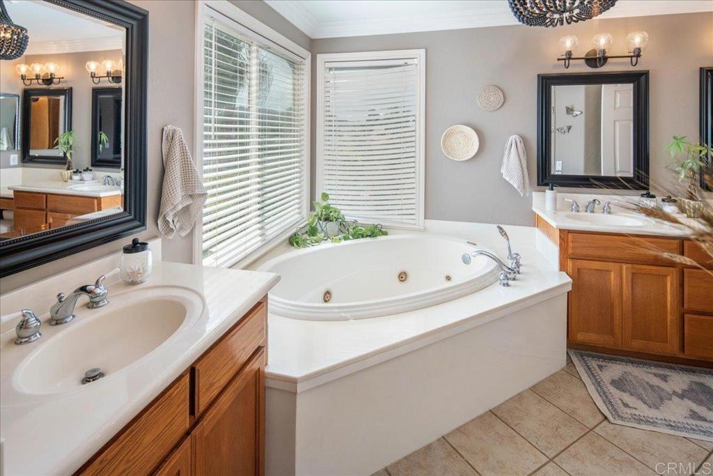 25057 Poderio Drive Ramona, CA 92065 - Photo 18 of 36 a bathroom with a bathtub sink and mirror