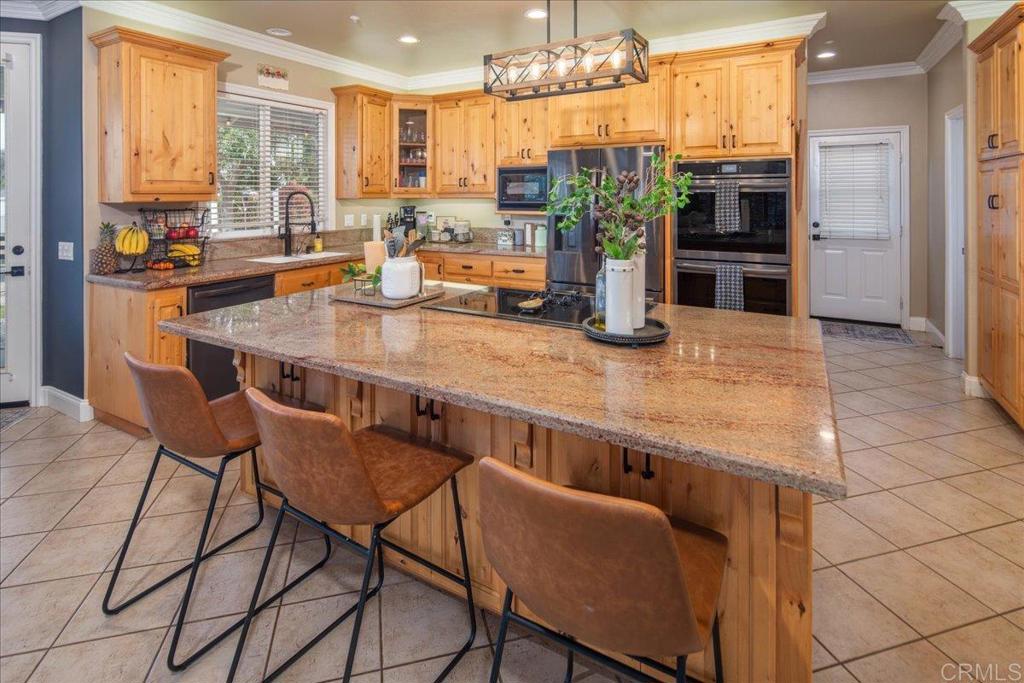 25057 Poderio Drive Ramona, CA 92065 - Photo 10 of 36 a view of a dining room with furniture a chandelier and wooden floor