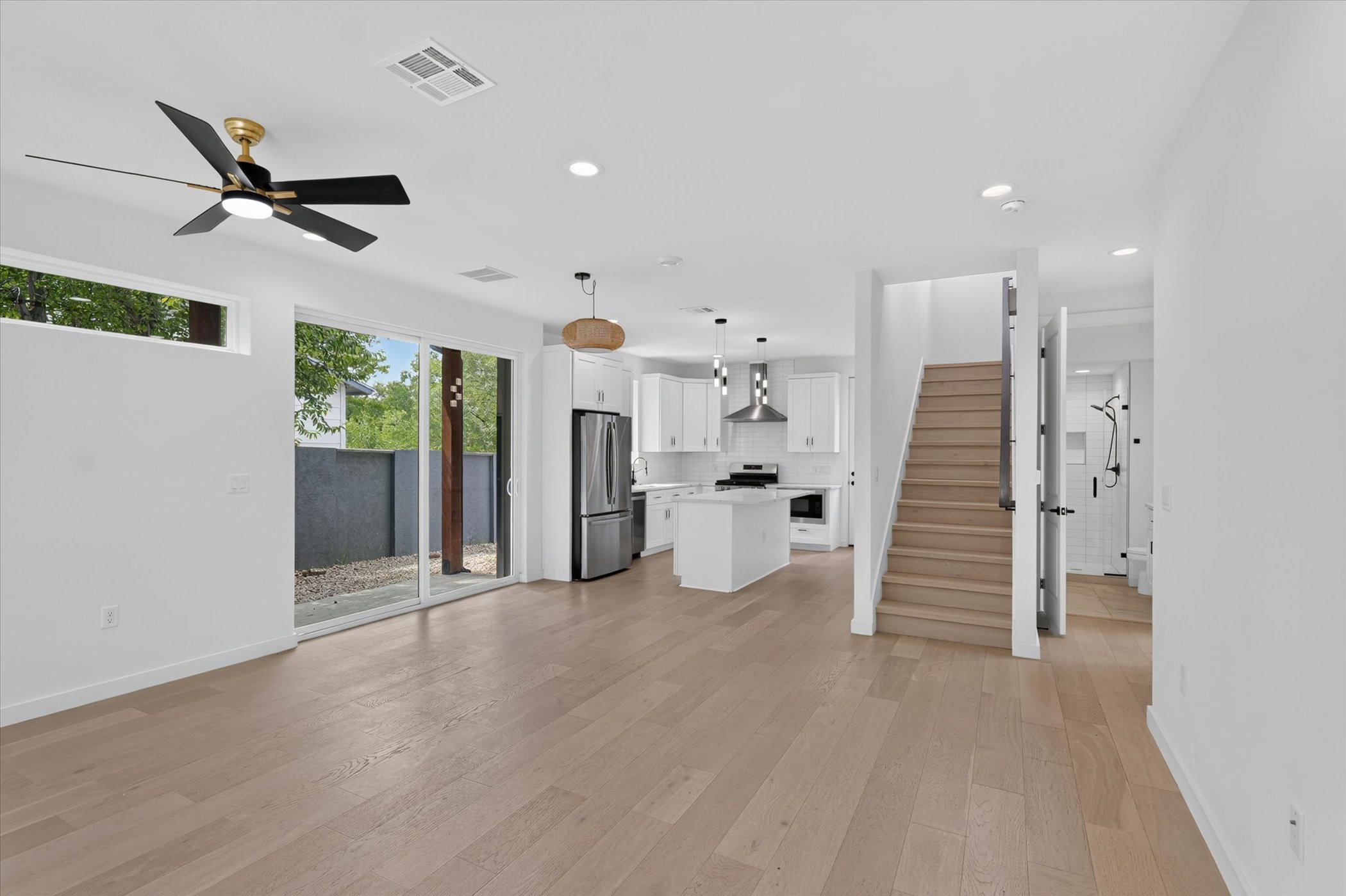 5305 Ledesma Road, Unit 1 Austin, TX 78721 - Photo 5 of 29 An open-concept main floor features light hardwood flooring and a contemporary kitchen with stainless steel appliances.