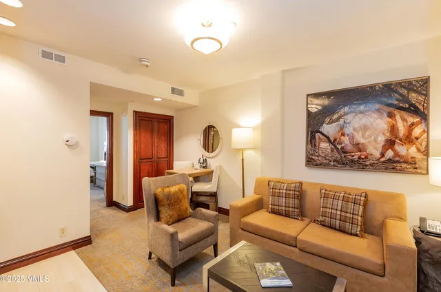 a living room with furniture and a mirror