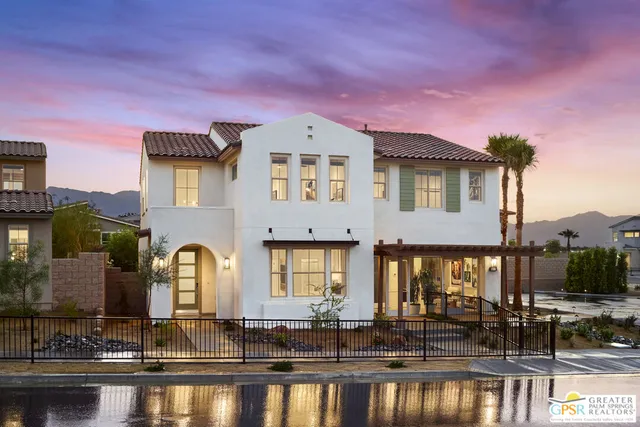 a front view of a house with swimming pool and outdoor seating