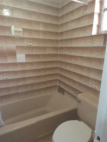 a bathroom with a toilet and a sink