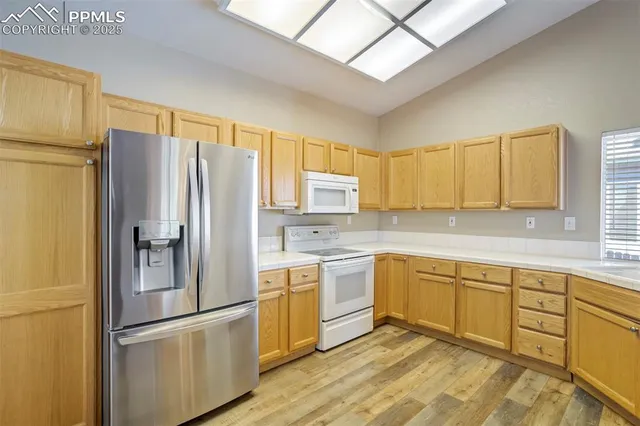a kitchen with a sink window and cabinets