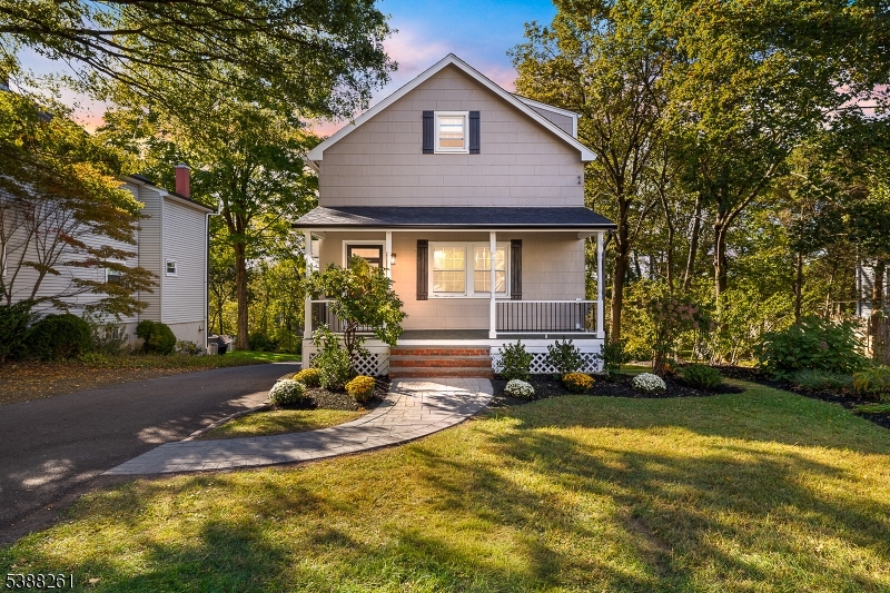 a front view of house with yard and trees around