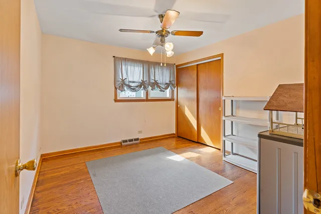 a view of a kitchen with wooden floor and a ceiling fan