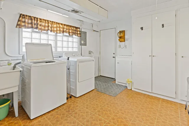 a view of a bedroom with closet dryer and washer