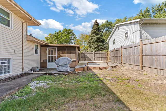 a view of a house with backyard and sitting area