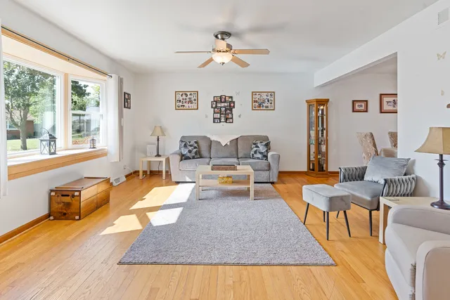 a living room with patio furniture and a large window