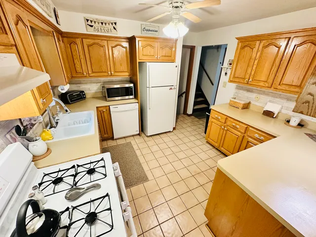 a kitchen with a sink appliances and cabinets
