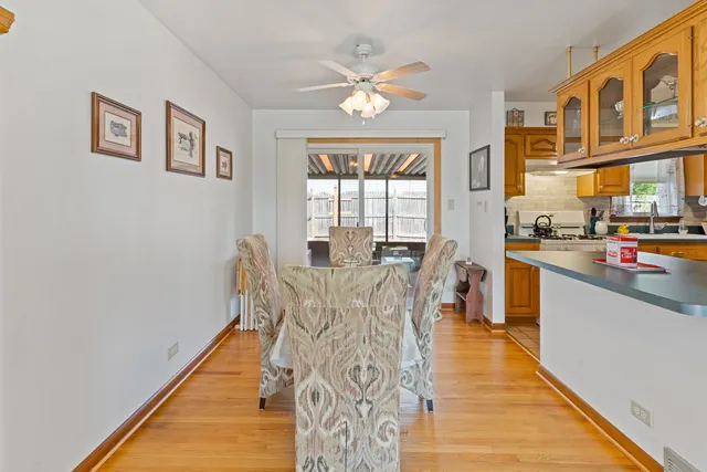 a view of a dining room with furniture a chandelier and wooden floor
