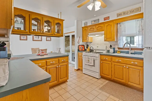 a kitchen with stainless steel appliances granite countertop a sink and cabinets