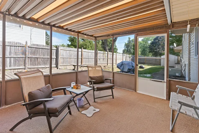 a outdoor space with a large window and furniture