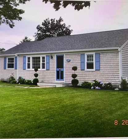 a front view of a house with a garden