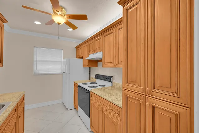 a kitchen with stainless steel appliances granite countertop a sink and cabinets
