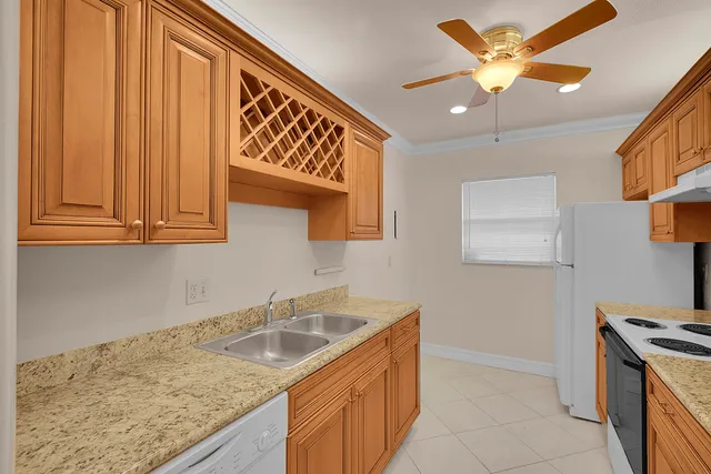 a kitchen that has a sink and a stove in it